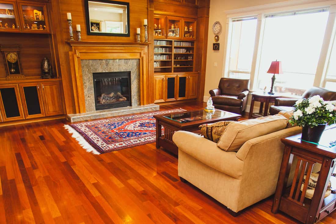Image of a luxury home with cherry hardwood floors, fire place, mantle, and furnishings, What Furniture Goes With Cherry Wood Floors?