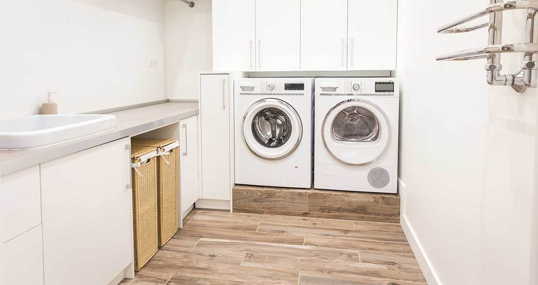 Laundry room in modern style with wooden floor