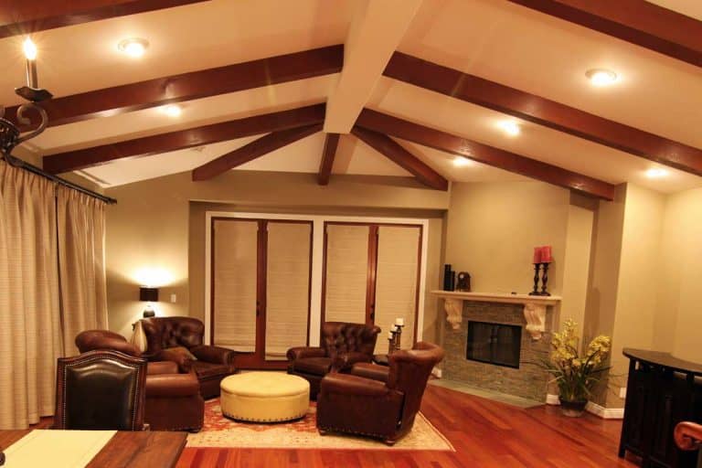Living room interior with fireplace, brown leather chairs and parquet floor, 15 Great Vaulted Ceiling Ideas