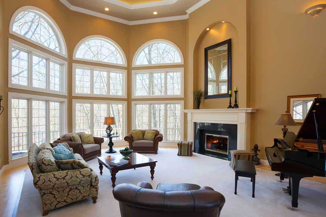 Luxury living room with fireplace, vaulted ceiling and grand piano, 15 Awesome High Ceiling Living Room Ideas