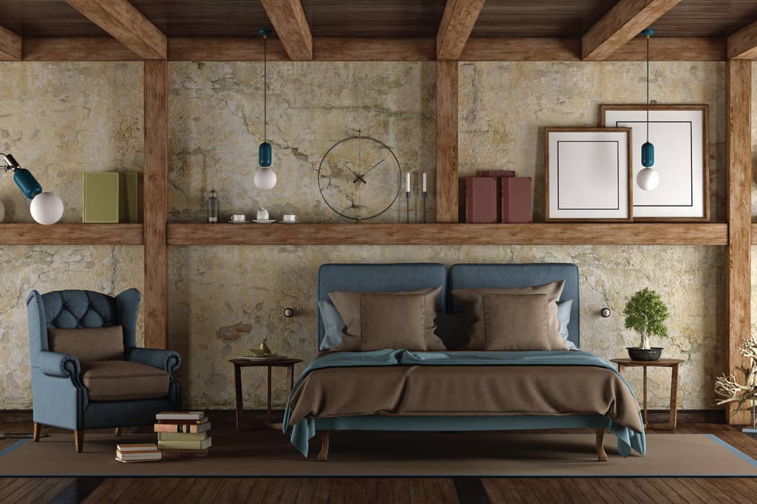 Master bedroom in rustic style with double bed and armchair. empty frames on the walls