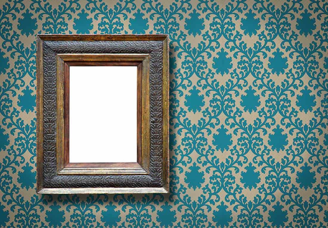 Ornate picture frame on wallpaper wall