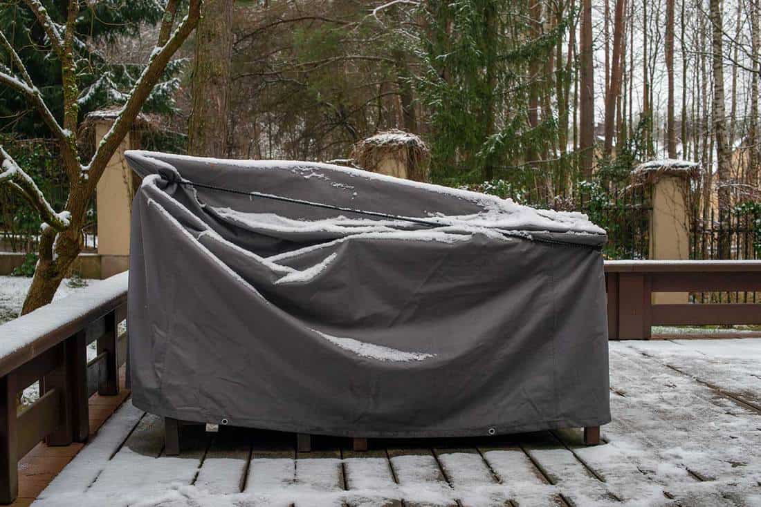 Patio furniture cover protecting outdoor furniture from snow