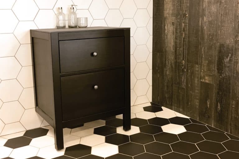 Spacious-bathroom-with-tiled-floor-and-wall,-and-black-drawer-unit.-What-Color-Paint-Goes-With-Black-And-White-Tile-[7-Noteworthy-Options]