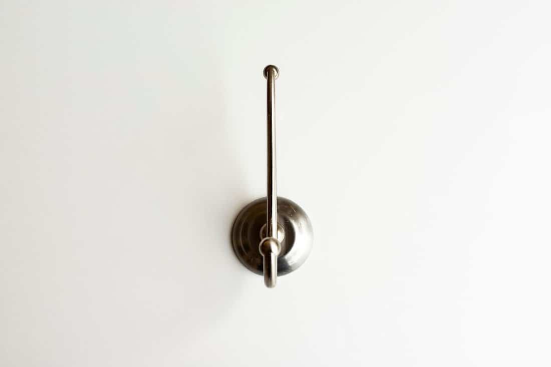Wall stainless steel hook on white background isolated.