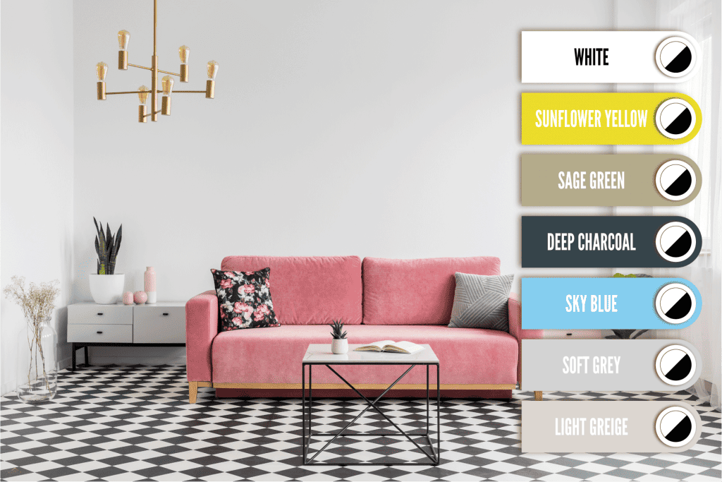 A pink sofa with two throw pillows inside a white walled living room with black and white tiles, What Color Paint Goes With Black And White Tile? [7 Noteworthy Options]