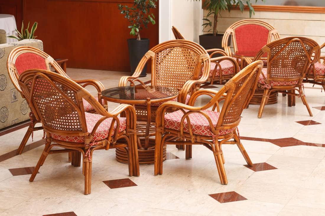 Wicker chairs and a round table in the lobby, close-up. horizontal