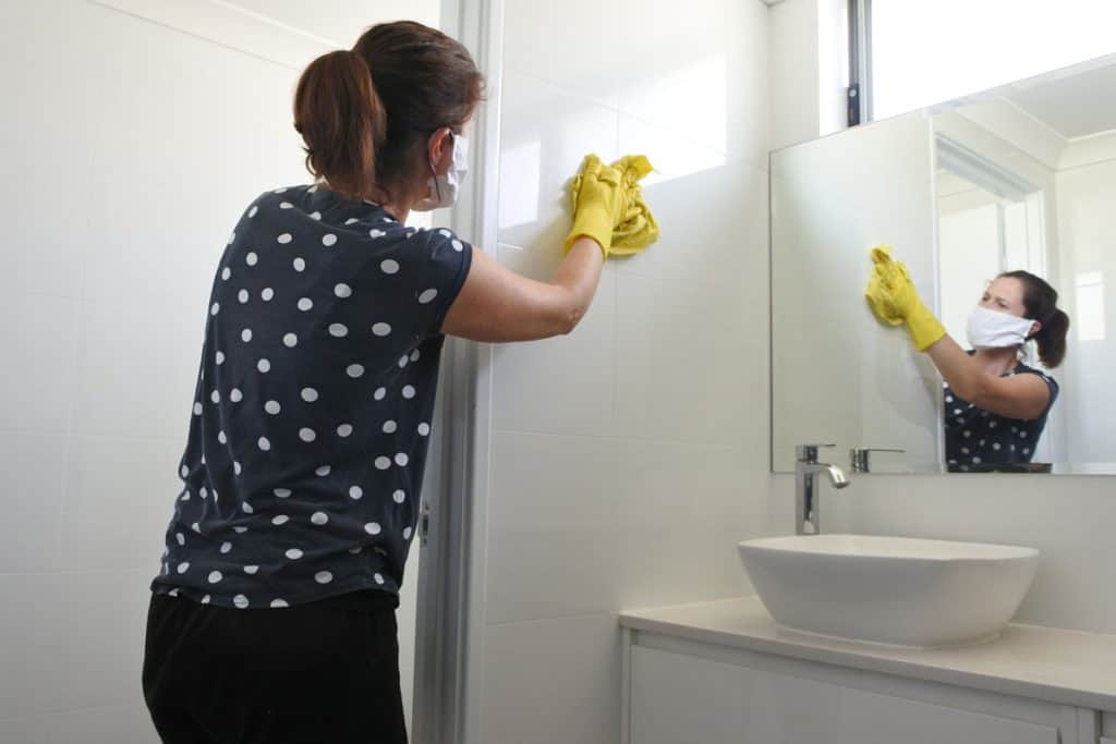Woman cleaning the bathroom 