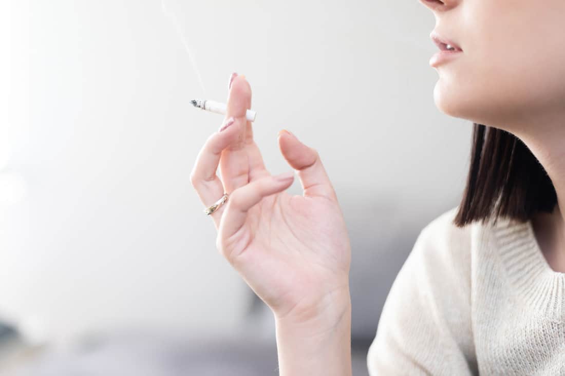 Woman smoking inside her room