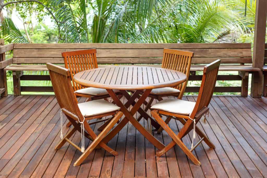 Wooden outdoor dining furniture with wooden flooring