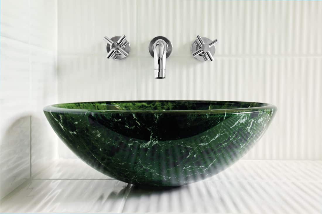 emerald green vessel sink in a white tile bathroom. Do Vessel Sinks Have Overflow