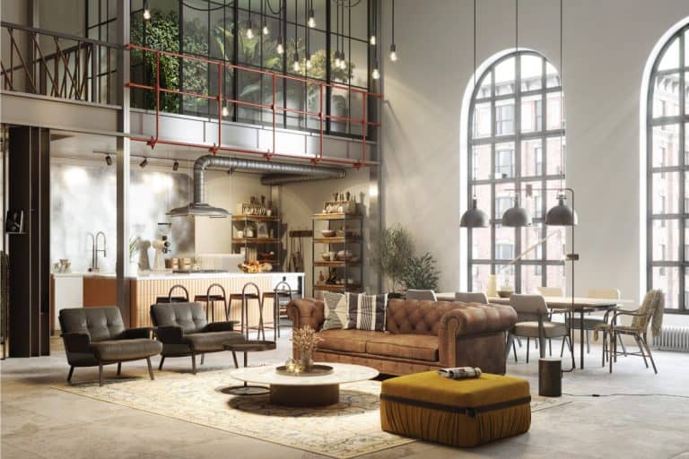 fully furnished living room. Modern interiors of a spacious living room. upholstered seats, sofa, center table, pendant lights, large windows. How To Furnish A Living Room [6 Must-Have Items And Ideas]