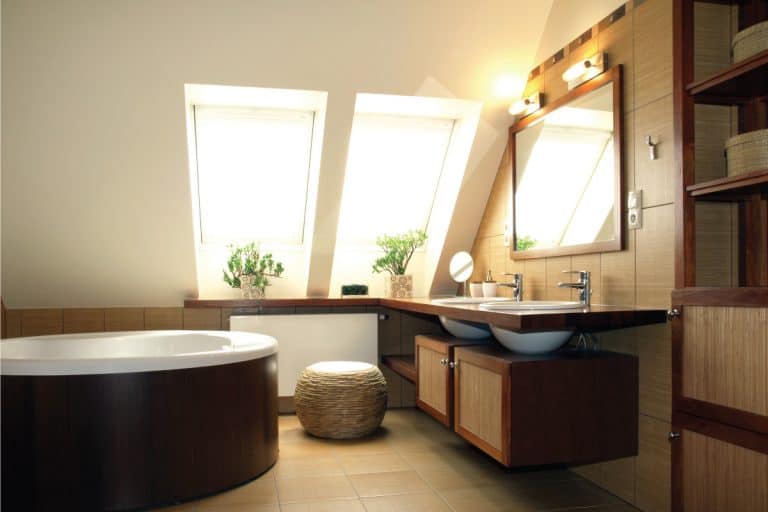 light brown themed attic bathroom with wooden accents, warm lighting. Can You Add A Bathroom To An Attic