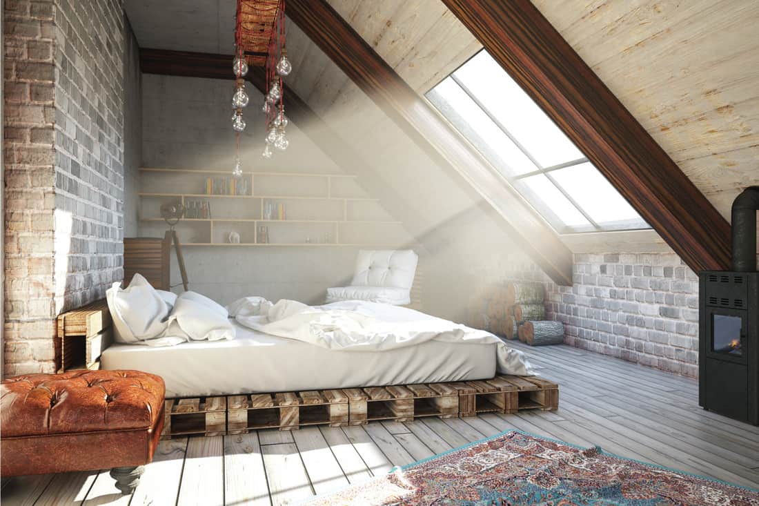 loft bedroom with brick walls and Pallet Bed Frame, light coming through the windows