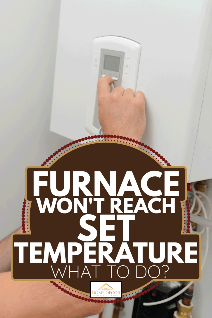 man fixing the home furnace thermostat. Furnace Won't Reach Set Temperature - What To Do