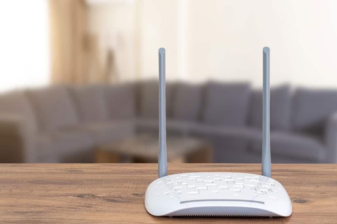 router on wooden table blurred living