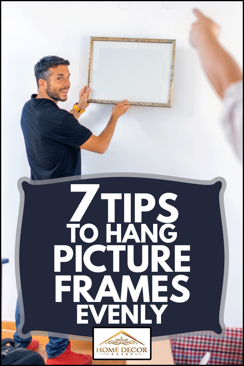 Couple hanging picture with frame on wall, 7 Tips To Hang Picture Frames Evenly