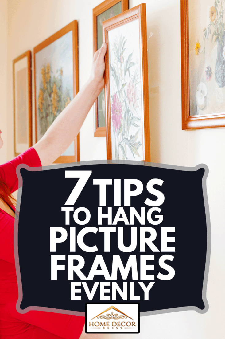 woman in red hanging the art pictures on wall at home, 7 Tips To Hang Picture Frames Evenly