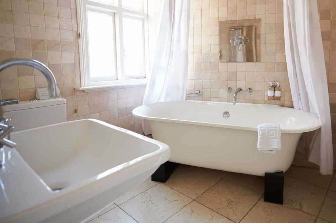 A bathroom with free standing bath and shower, How To Tell If A Bathtub And Shower Are Fiberglass Or Acrylic