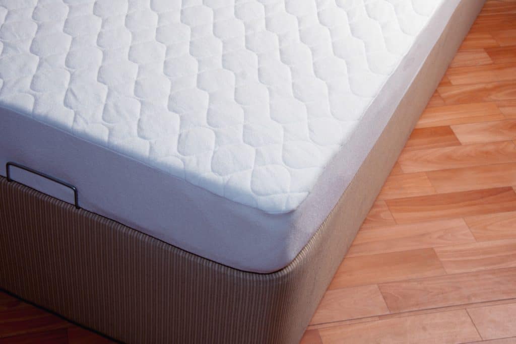A comfortable mattress placed on a laminated flooring