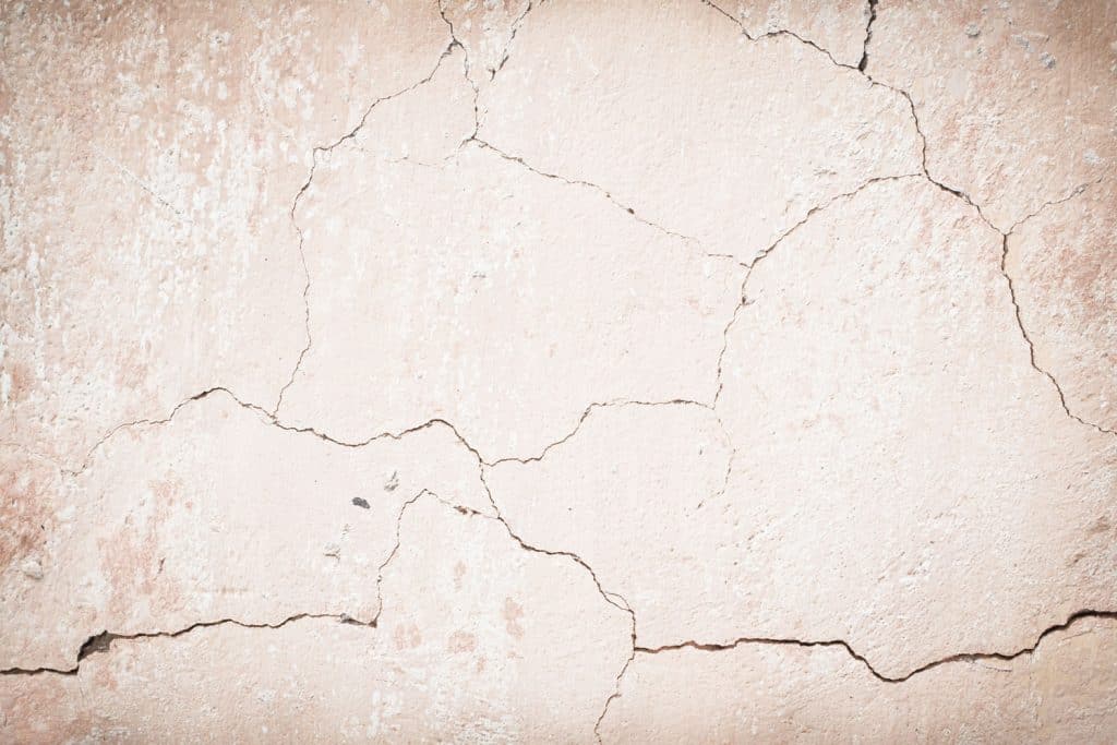 A detailed photo of a cracked exterior of a house