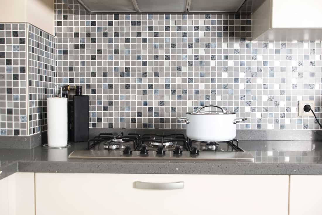 A gorgeous modern kitchen with small tiled backsplash on the background, How To Choose Grout For Your Backsplash