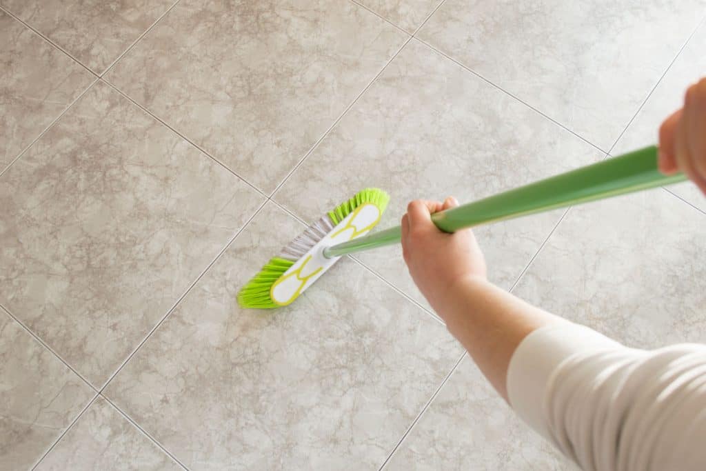 Eine Frau, die den Boden ihres Wohnzimmers putzt