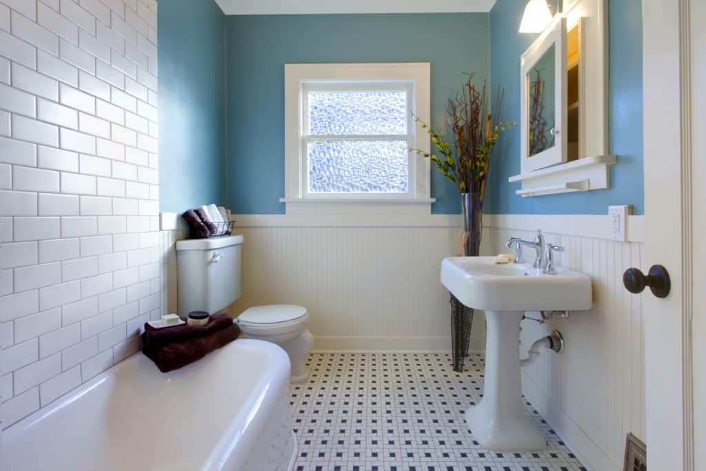 Antique luxury design of blue and mostly white bathroom
