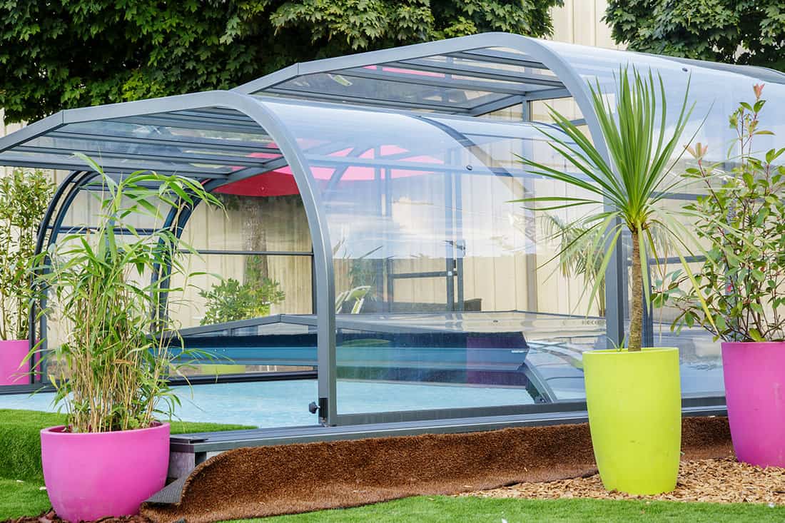Automatic retractable pool enclosure system to protect pool