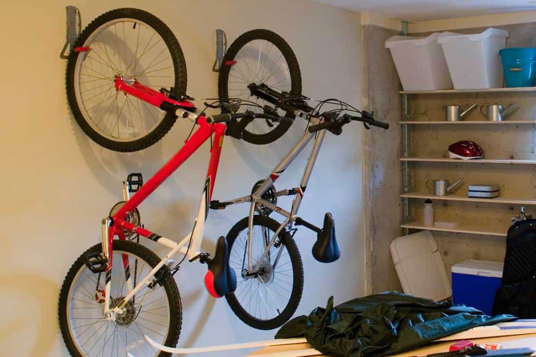 Basement house clutter garage storage with bike hanging on wall, 5 Of The Best Bike Hooks For Your Garage Wall