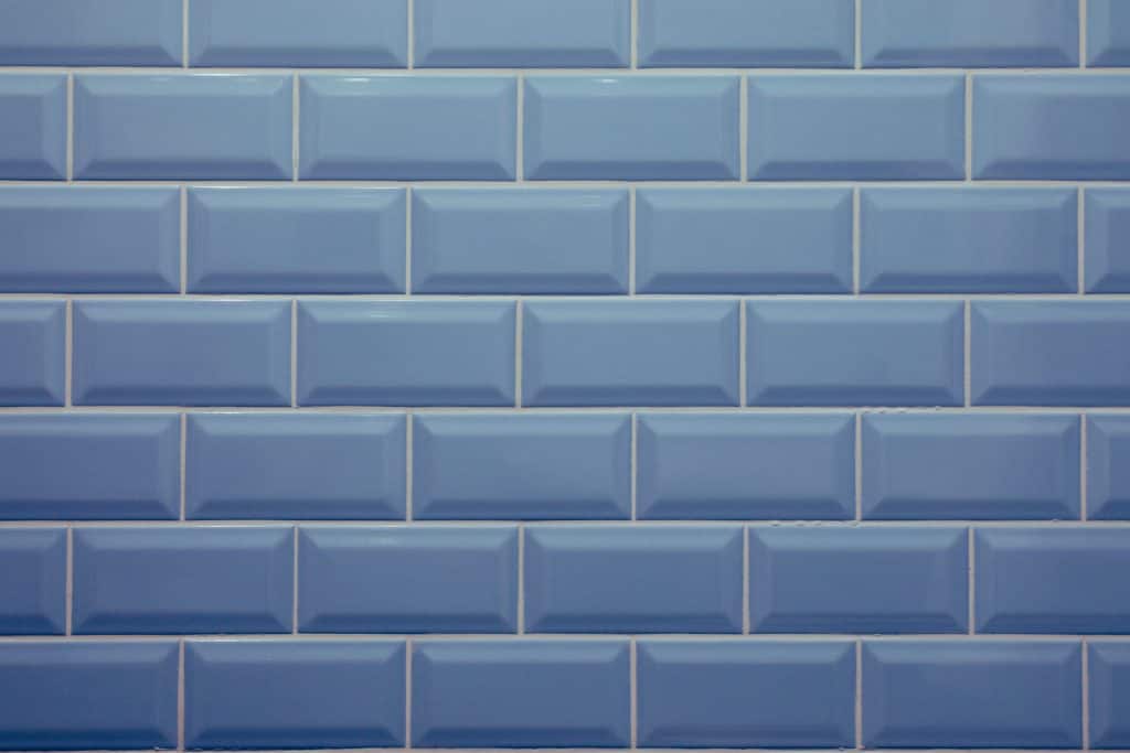 Blue tile wall with nobody and space for text, trend color 2020 faded denim