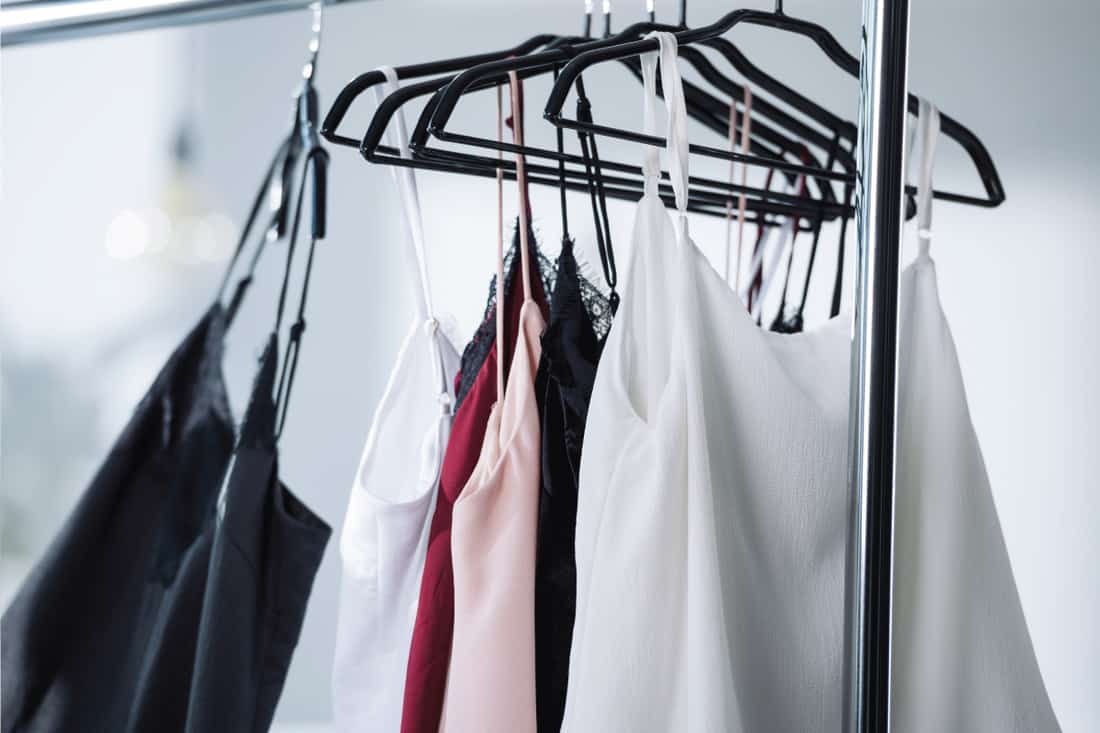 Close-up-shot-of-various-dresses-hanging-on-rack-using-hangers.-5-Places-To-Store-Hangers-In-Laundry-Room, 5 Places To Store Hangers In Laundry Room