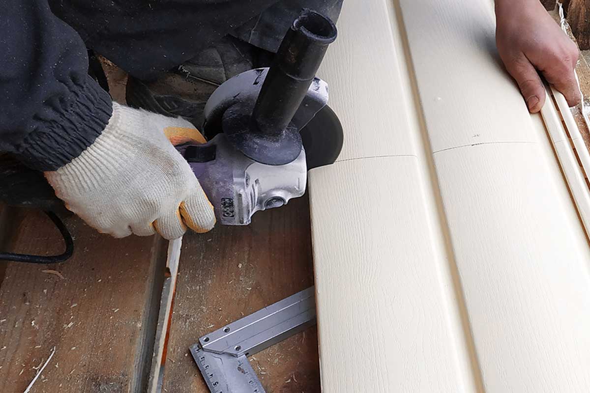 Employee cuts siding to the required size, 10 Of The Best Vinyl Siding Cutters To Check Out