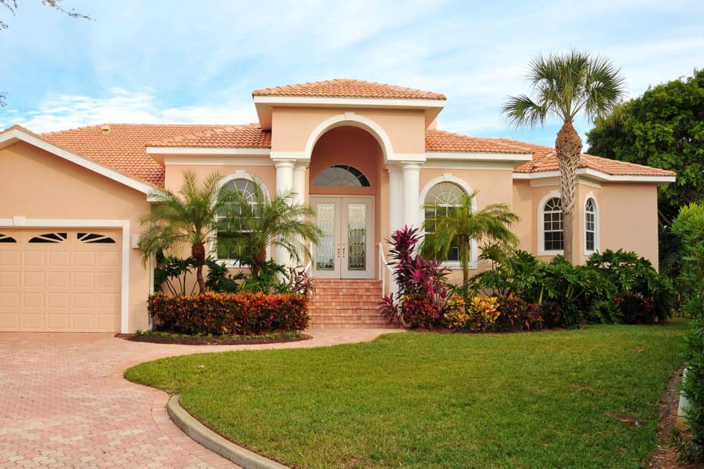 Florida home with stucco walls and red brick roofing