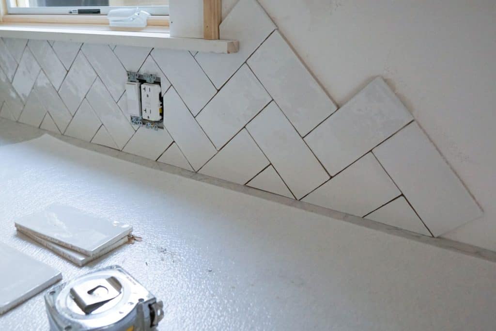 Installing tiled backsplash for the kitchen