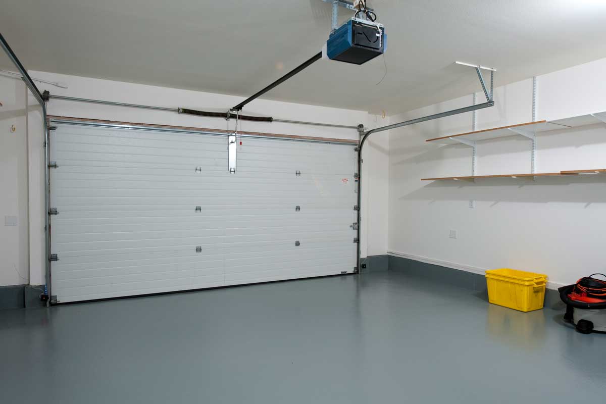 Interior of a clean garage in a house with white walls and gray floor, Should Garage Walls Be Textured?
