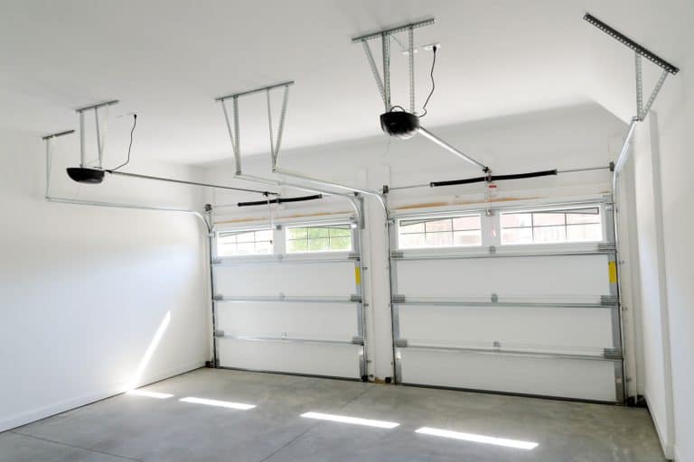 Interior of a garage with two garage door openers, 5 Types Of Garage Door Openers [Plus Some Need To Know Info]