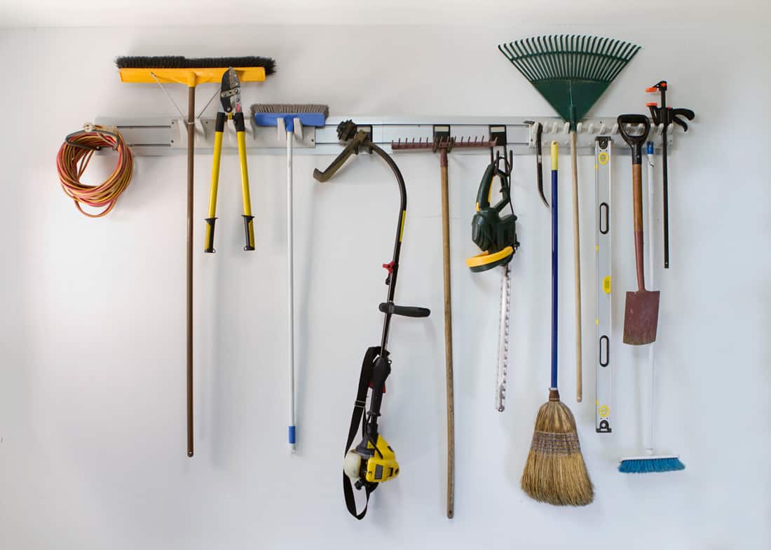 Neat garage tools hanging on a storage rack