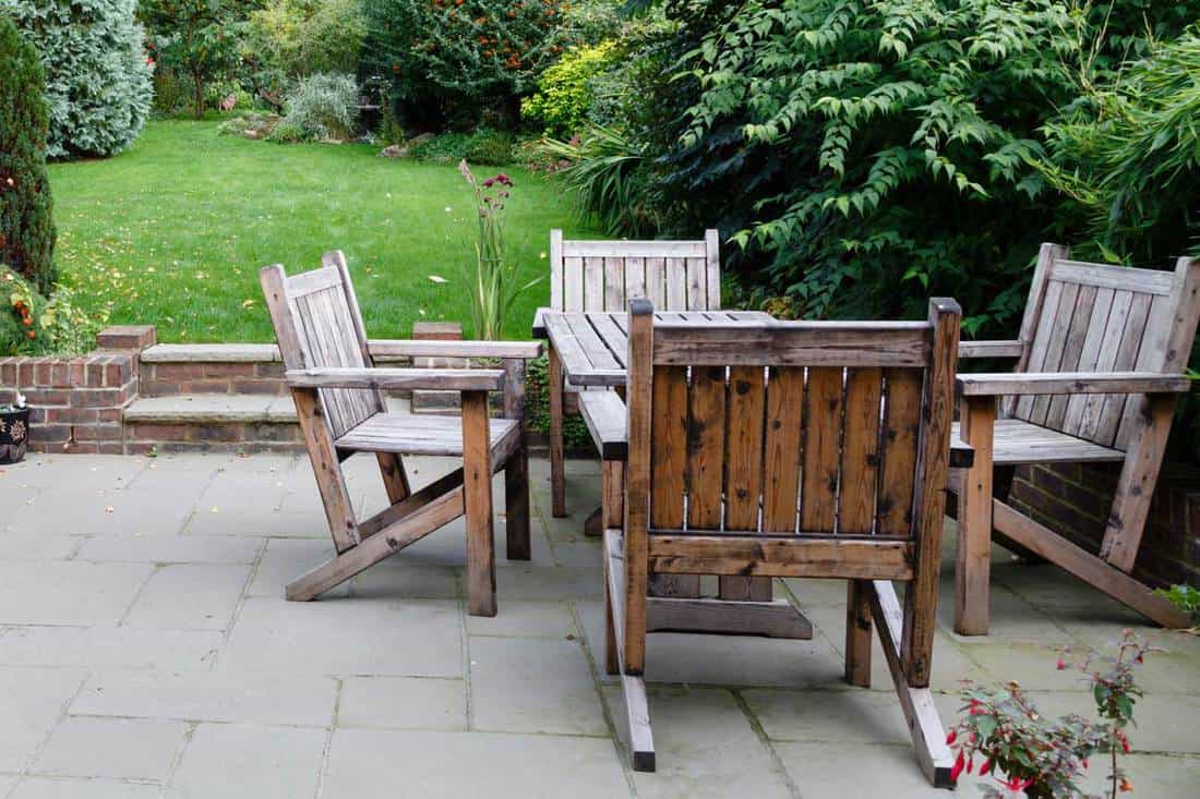 Patio garden with wooden table and chairs, How To Restore Outdoor Wood Furniture In 4 Easy Steps