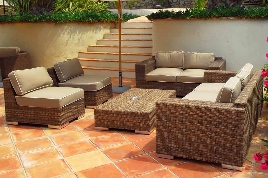 Patio of a villa with wicker furniture, How To Refinish Rattan Furniture In 7 Easy Steps