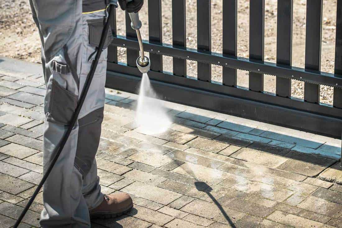 Pressure washing the driveway and gate, Should You Seal Your Concrete Driveway? [A Thorough Look At Pros And Cons]