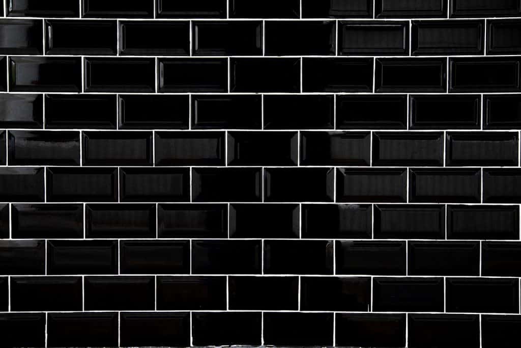 Properly laid black tiles with white grout