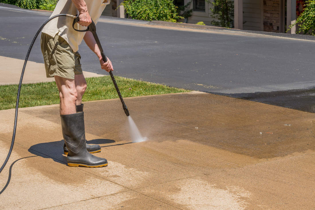 Senior man pressure spraying concrete driveway, 9 Of The Best Pressure Washers For A Driveway