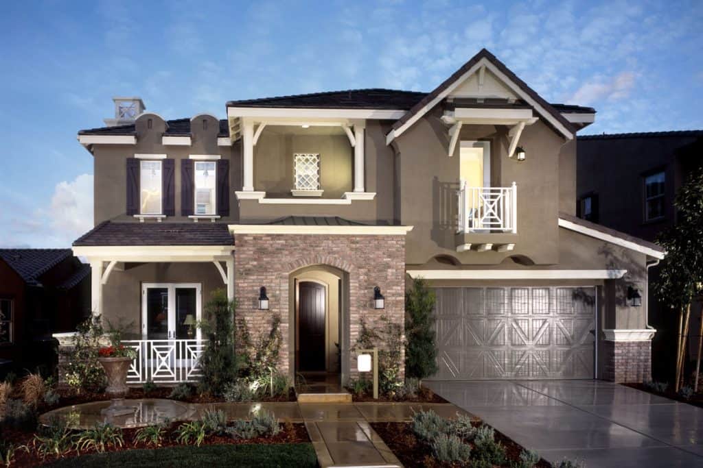 Two story house with black shutters, white trims and stucco exterior wall