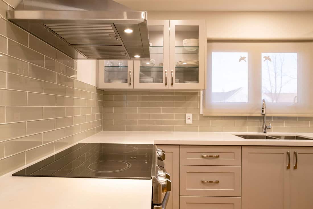 White kitchen backsplash and white cabinets matching the white countertop