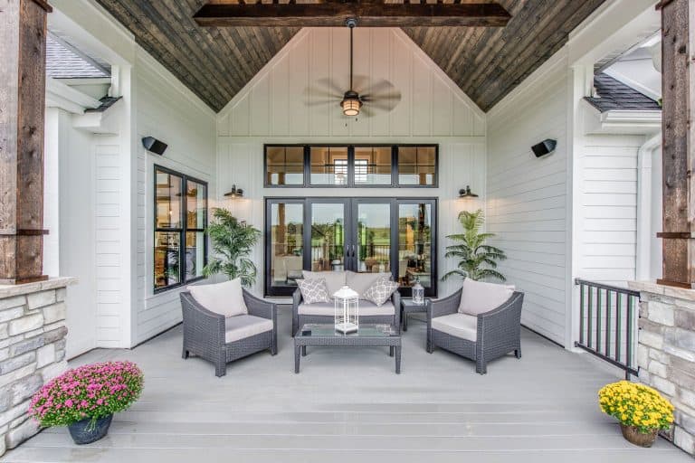 Wood panel vaulted covering on outdoor gathering area of new home, Which Outdoor Ceiling Fan Moves The Most Air? [5 Options Explored]