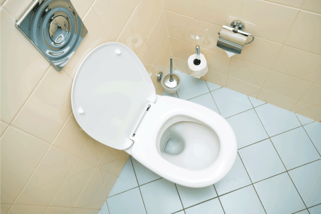clean toilet in a bathroom with light blue tile. Do Toilets Lose Flushing Power Over Time [And How To Increase Flush Pressure!]