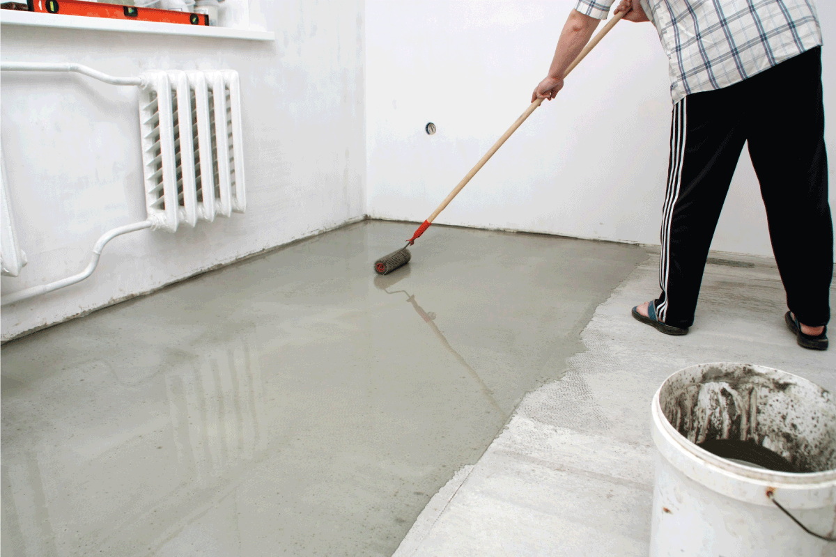 man-repairing-garage-floor,-sealing-garage-floor.-Should-A-New-Garage-Floor-Be-Sealed