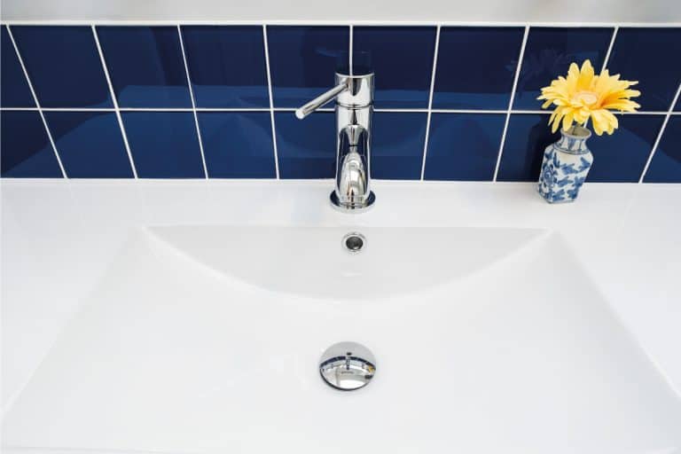 shiny blue tile backsplash of a ceramic sink with chrome faucet. How To Paint Tile Backsplash In 7 Simple Steps