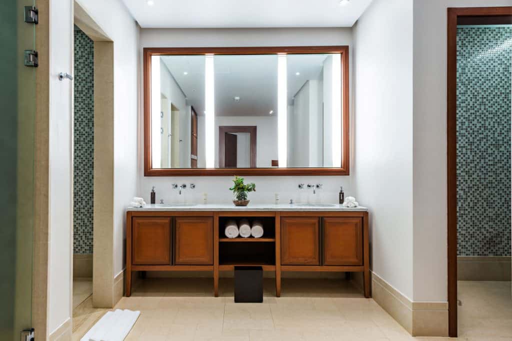 A modern contemporary bathroom vanity with wooden cabinetry